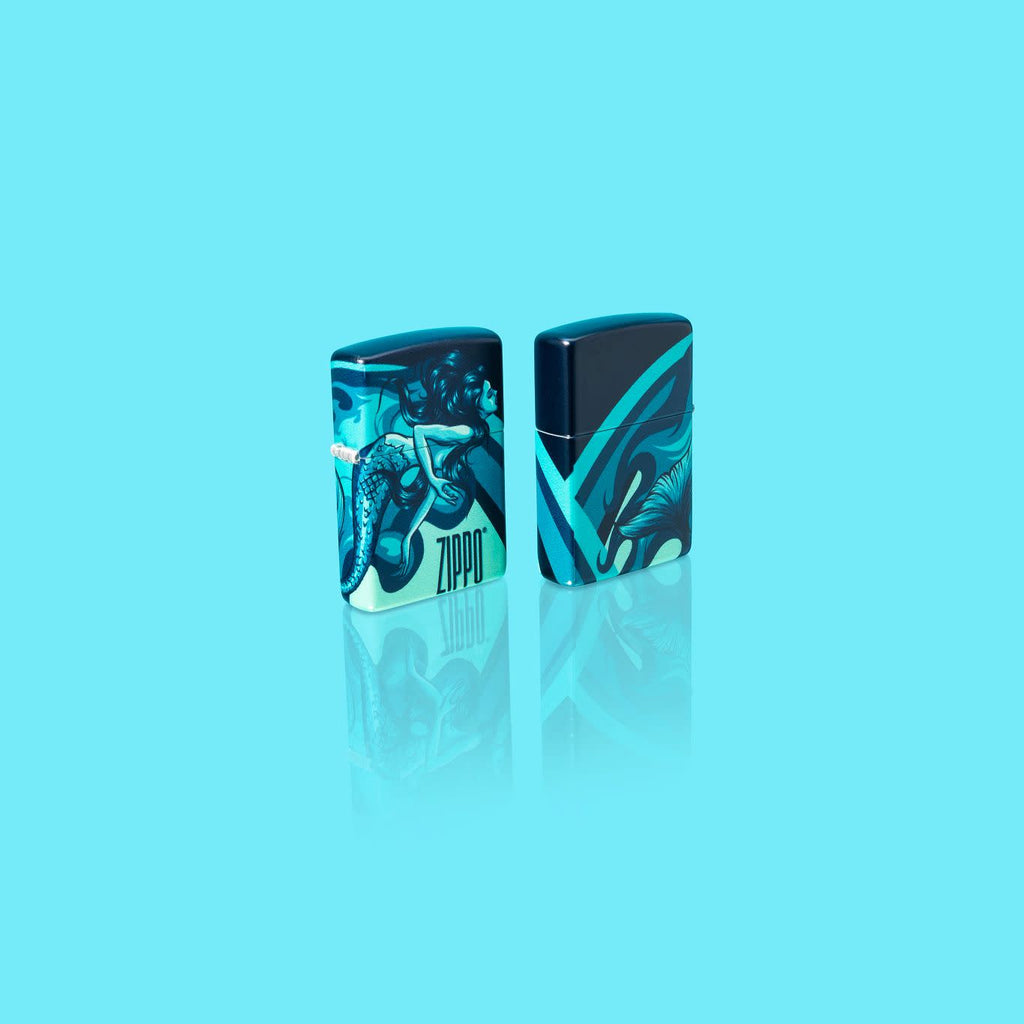 Glamour Shot of two Zippo Mermaid Design 540 Color Windproof Lighters standing in a blue scene.
