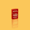Glamour shot of Zippo Muscle Car Design Metallic Red Windproof Lighter standing in a yellow scene.
