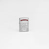 Lifestyle image of Zippo Iron Maiden Eddie Street Chrome Windproof Lighter in a grey scene.
