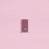 Lifestyle image of Zippo Checkered Skull Design Slim Pink Matte Windproof Lighter in a pink scene.