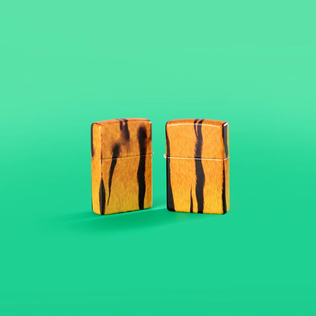 Lifestyle image of Tiger Print Designs 540 Color Windproof Lighters standing in a green background.