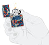Kimono Design 540 Color Windproof Lighter lit in hand.