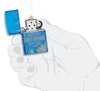 Harley-Davidson 360° Flames High Polish Blue Windproof Lighter lit in hand.