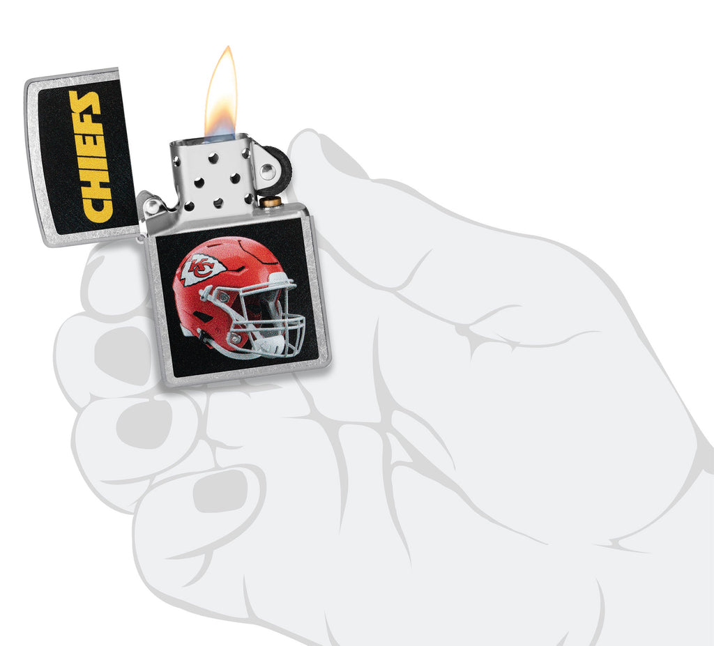NFL Kansas City Chiefs Helmet Street Chrome Windproof Lighter lit in hand.