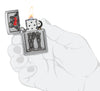 Zippo Couple Love Emblem Brushed Chrome Windproof Lighter lit in hand.